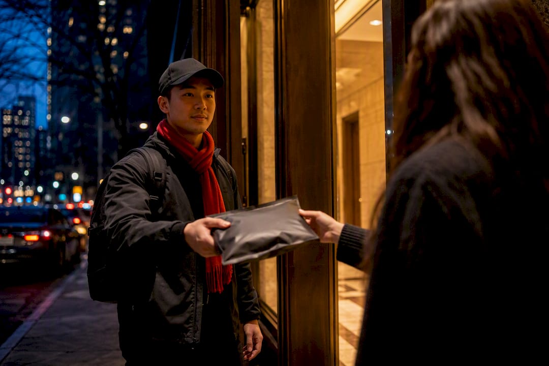 Courier making discreet delivery handoff